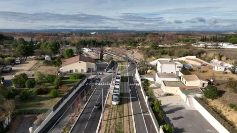 Aerial view of Montpellier tramway modern tram on elevated tracks curving Stock Footage 337976914