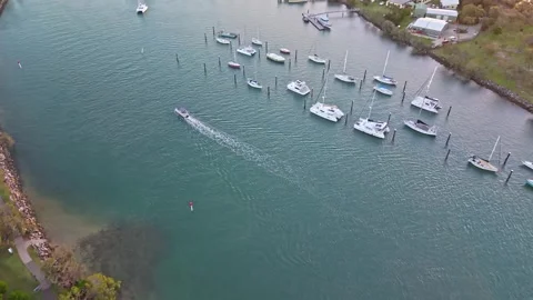 Aerial view of moored yachts on Mooloolah River near beach Queensland Stock Footage 333445494