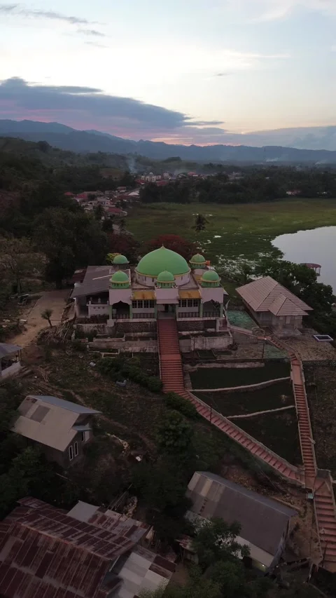 Aerial view of a mosque on the hill in the evening as the sunset Stock-Footage 260373700