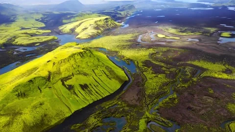 Aerial view of moss covered terrain with winding rivers and mountains Stock-Footage 341328689