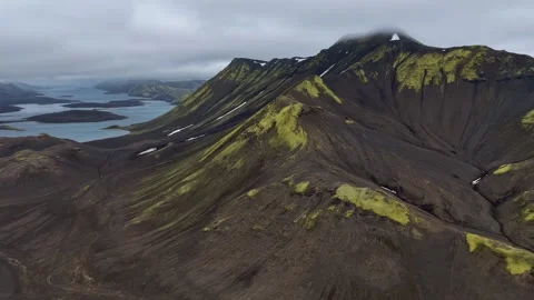 Aerial view of moss-covered volcanic mountain with glacial lakes, Iceland Highla Stock Footage 341606372