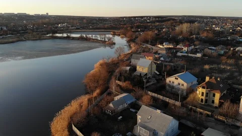 Aerial view in motion of Eastern European village by the river Stock Footage 88333997