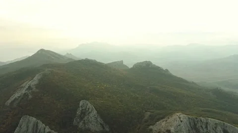 Aerial view with motion on mountain slopes with protruding sharp rocks in the Stock Footage 258480287