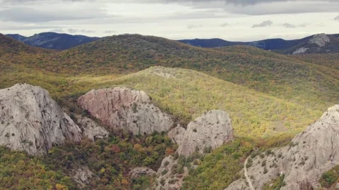 Aerial view with motion on mountain slopes with protruding sharp rocks in Stock Footage 277420089