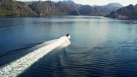 Aerial View of Motorboat Navigating Fast on Water of Cennet Bay Stock Footage 219219723