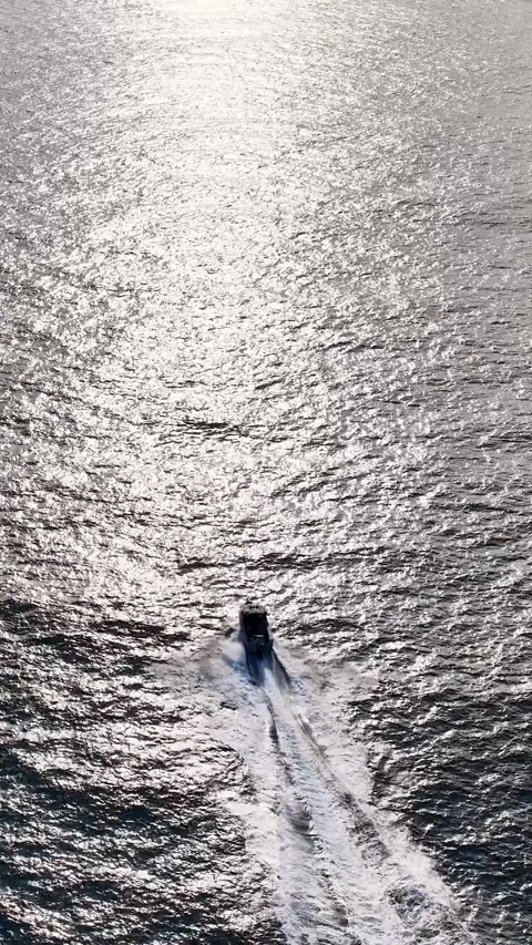 Aerial View of Motorboat Speeding Through Sparkling Ocean Water Stock Footage 341455076