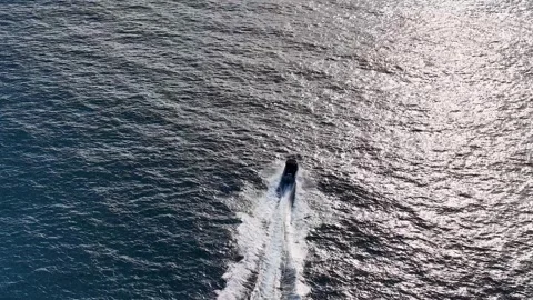 Aerial View of Motorboat Speeding Through Sparkling Ocean Water Stock Footage 341456997