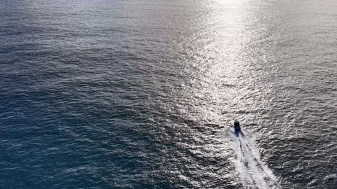 Aerial View of Motorboat Speeding Through Sparkling Ocean Water Stock Footage 341542640