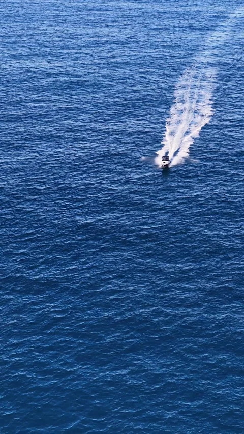 Aerial View of Motorboat Speeding Through Blue Ocean Water Stock Footage 341642890