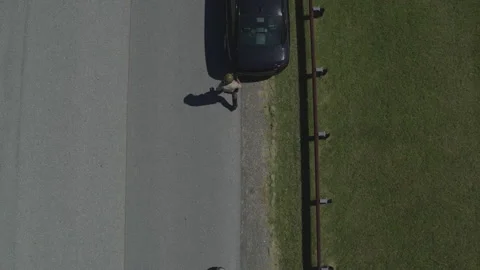 Aerial View of Motorcycle Cop Pulling over Sports Car for Traffic Violation Stock Footage 222010448