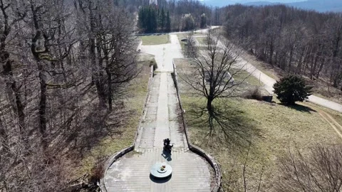 Aerial view of a motorcyclist riding down the stairs of the Petrova Gora Stock Footage 331237172