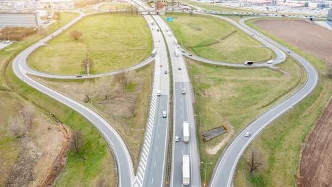 Aerial view of a motorway with interchanges, many trucks are driving on the r Stock Photos