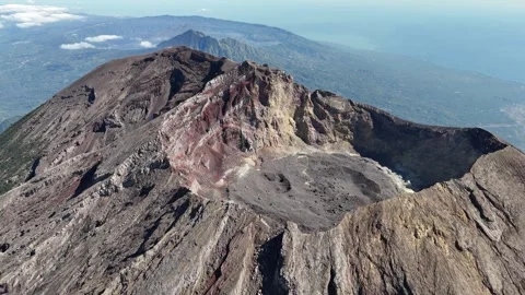 Aerial view of Mount Agung and sea in the background in Bali, Indonesia Stock Footage 284397387