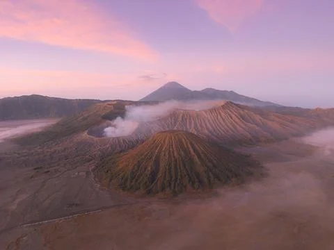 Aerial view of Mount Bromo piercing through a sea of swirling clouds under .. Foto stock