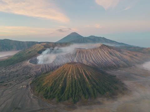 Aerial view of Mount Bromo piercing through a sea of swirling clouds under .. Foto stock
