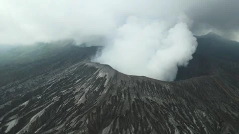 Aerial view of Mount Bromo volcano in Indonesia, active crater emitting smoke Stock Footage 295763920