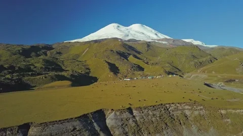 Aerial view of Mount Elbrus from the height of the Emmanuel Glade. Flying past a Stock Footage 151773798