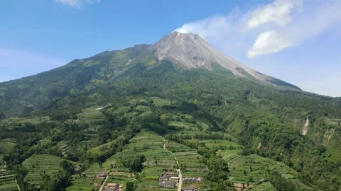 Aerial view of Mount Merapi and lush green farmlands in Central Java, Indonesia Stock Footage 306758793
