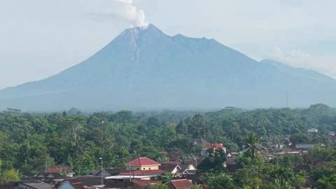 Aerial view of Mount Merapi volcano and village, Indonesia. Stock Footage 334768981