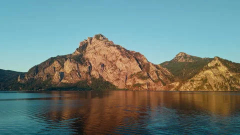 Aerial view of Mount Traunstein peak above Lake Traunsee water at sunset Видео 344181896