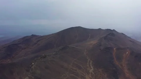 Aerial view of the mountain against the background of clouds and a mountain Stock Footage 165808747