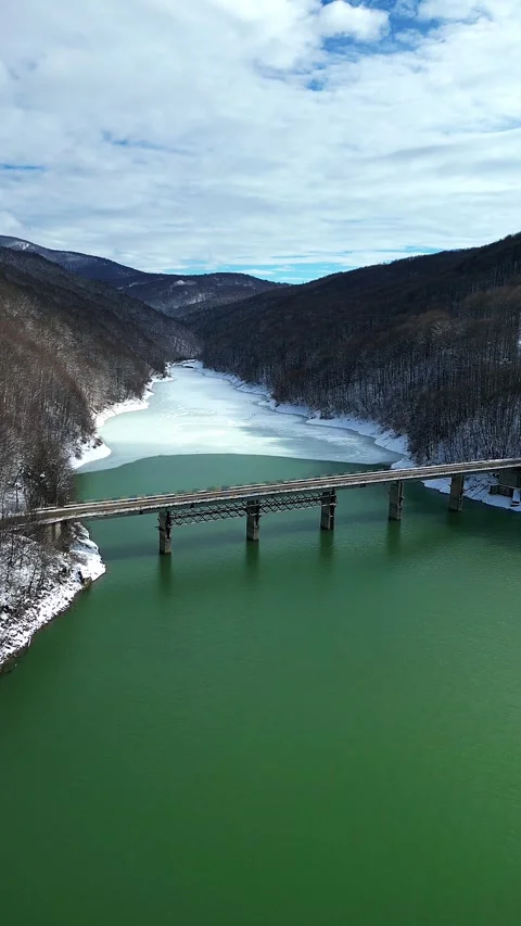 Aerial View of Mountain Bridge Over Emerald River During Early Spring Thaw Stock Footage 330240248