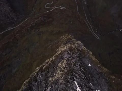 Aerial View of Mountain Cliff Looking over Winding Road Mountain Valley Forest Stock Footage 82980974