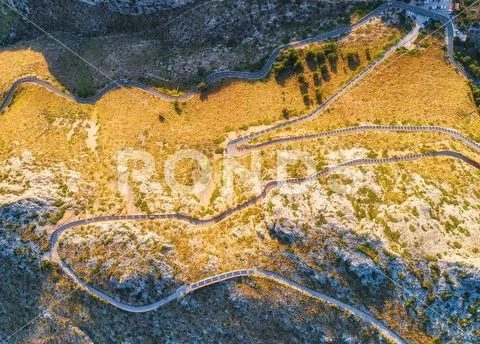 Aerial view of mountain curve road with cars, green forest Stock Photos