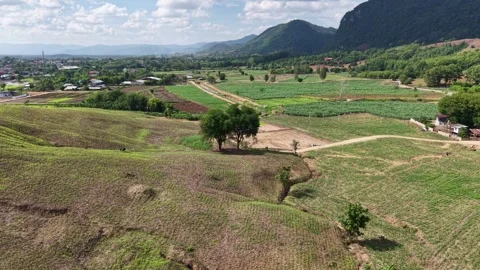 Aerial View of Mountain Fields and Clouds Gathering Stock Footage 310883205