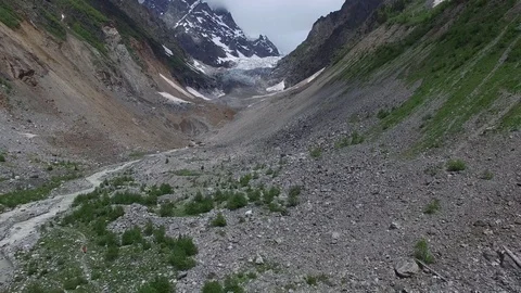 Aerial view of the mountain gorge in front of the glacier Stock-Footage 77057869