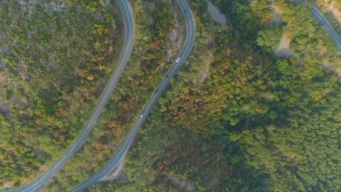 Aerial View Of Mountain Pass And Cars Driving Along Road. Drone following cars Stock Footage 116486131