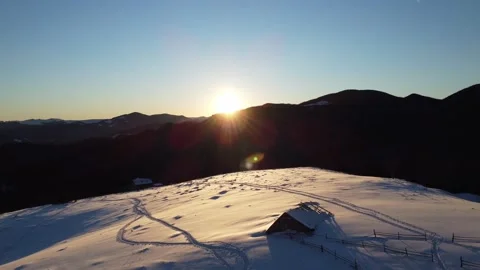 Aerial view of mountain peak during winter sunrise with building on top. Ukraine Stock Footage