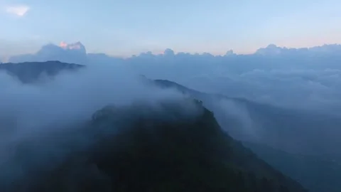 Aerial View of Mountain Peak Emerging from Morning Fog 스톡 동영상 341778192