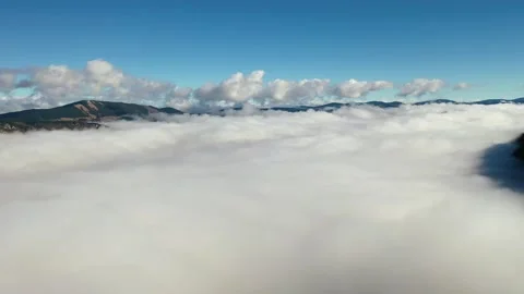Aerial view of mountain range above clouds Stock Footage 256212345