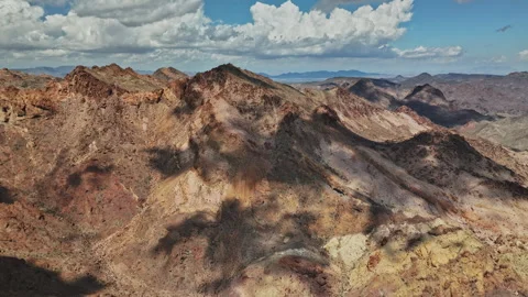 An aerial view of a mountain range with clouds in the sky Stock Footage 252309148