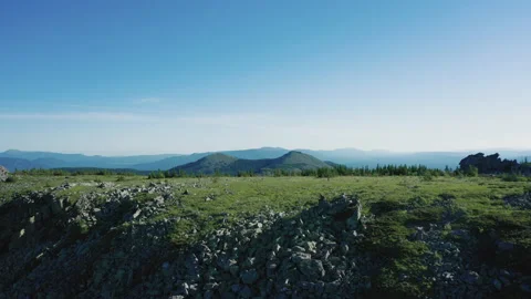 Aerial view of mountain range with pano of overgrown slopes and stone peaks Stock Footage 138005377