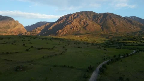 Aerial view mountain range with a road running through it Stock Footage 328011554