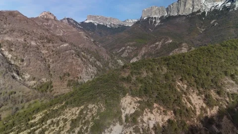 Aerial view of a mountain range with snow on it Видео 329627982