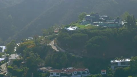Aerial view of mountain range suburban mansions in Brentwood area on a sunny day Stock Footage 199460078