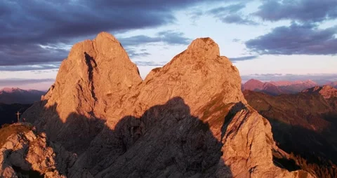 Aerial View of Mountain Range at Sunset in the Alps with Summit Cross Stock Footage 236499407