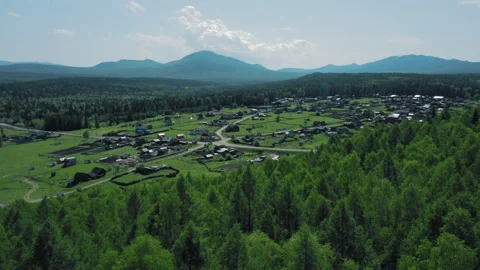 Aerial view of mountain range in Ural and little households Stock Footage 135394660
