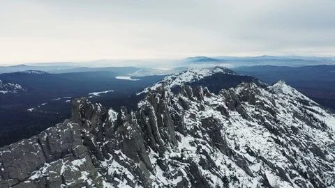 Aerial view of mountain range in winter day, drone moves sideways Stock Footage 120818990