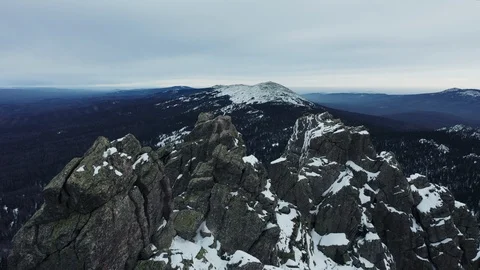 Aerial view of mountain range in winter day, drone moves down Stock Footage 120820321