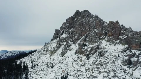 Aerial view of mountain range in winter day, drone moves backward Stock Footage 120821103