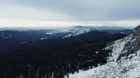 Aerial view of mountain range in winter day, drone moves backward Stock Footage 120821543