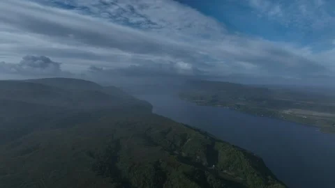 Aerial view Mountain Reflections on Calm Water Under a Cloudy Sky Stock Footage 312746994