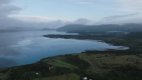 Aerial view Mountain Reflections on Calm Water Under a Cloudy Sky Stock Footage 312748462