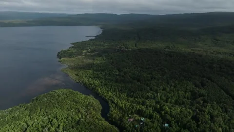 Aerial view Mountain Reflections on Calm Water Under a Cloudy Sky Stock Footage 312749337