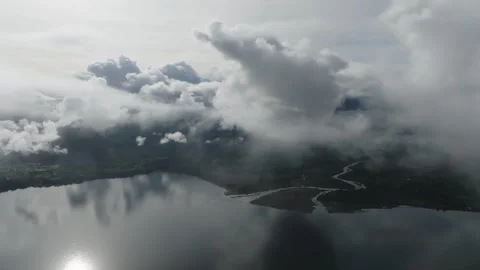 Aerial view Mountain Reflections on Calm Water Under a Cloudy Sky Stock Footage 312750201