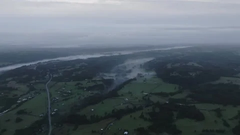 Aerial view Mountain Reflections on Calm Water Under a Cloudy Sky Stock Footage 312750705